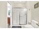 Bright bathroom with white tile shower featuring a bench seat and a convenient grab bar at 4495 W Stones Crossing Rd, Greenwood, IN 46143