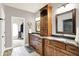 Bathroom features wood cabinets, granite countertops, and a view into another room at 4495 W Stones Crossing Rd, Greenwood, IN 46143