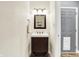Bathroom with vanity, wood-look floors, and a gray door with a dog door at 4495 W Stones Crossing Rd, Greenwood, IN 46143