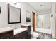 Bathroom featuring a double vanity with dark wood cabinets and a shower tub with glass doors at 4495 W Stones Crossing Rd, Greenwood, IN 46143