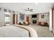 Large bedroom with a brick fireplace, TV, desk and chair, and a large window at 4495 W Stones Crossing Rd, Greenwood, IN 46143