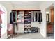 Spacious walk-in closet with custom shelving and ample storage, adjacent to a bathroom at 4495 W Stones Crossing Rd, Greenwood, IN 46143