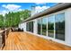 Spacious wooden deck features seating area and multiple sliding glass doors at 4495 W Stones Crossing Rd, Greenwood, IN 46143