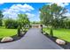 Long driveway leading to a beautiful home with lush landscaping and a separate garage, creating a welcoming entrance at 4495 W Stones Crossing Rd, Greenwood, IN 46143