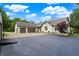 Exterior view of a well-maintained home featuring an attached garage and a spacious driveway at 4495 W Stones Crossing Rd, Greenwood, IN 46143