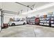 Spacious garage with overhead storage and room for two cars plus storage on shelving at 4495 W Stones Crossing Rd, Greenwood, IN 46143