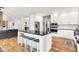 Bright kitchen with a center island, stainless steel appliances, and white cabinetry at 4495 W Stones Crossing Rd, Greenwood, IN 46143