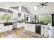 Spacious kitchen features an island with wine cooler, stainless steel appliances, and an undermount sink with window at 4495 W Stones Crossing Rd, Greenwood, IN 46143