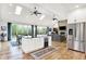 Spacious kitchen with island, stainless steel refrigerator, and views of the backyard at 4495 W Stones Crossing Rd, Greenwood, IN 46143