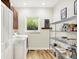 Laundry room and pantry with white cabinets, shelves, a window and appliances at 4495 W Stones Crossing Rd, Greenwood, IN 46143