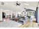 Open-concept living room with vaulted ceilings, skylights, hardwood floors, and a view into the kitchen and dining area at 4495 W Stones Crossing Rd, Greenwood, IN 46143