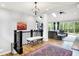 Open concept living space with hardwood floors, skylights, and access to the outdoor deck at 4495 W Stones Crossing Rd, Greenwood, IN 46143