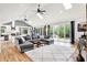 Open concept living space with hardwood floors, skylights, and access to the outdoor deck at 4495 W Stones Crossing Rd, Greenwood, IN 46143