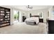 Spacious bedroom with natural light, neutral carpet and a sliding door to the backyard at 4495 W Stones Crossing Rd, Greenwood, IN 46143