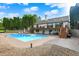 Exterior view of a house featuring a swimming pool, a wooden deck, and a well-maintained yard with mature trees at 4495 W Stones Crossing Rd, Greenwood, IN 46143
