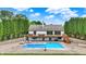 Beautiful backyard featuring a swimming pool, wooden deck, and charming white house with lush green surroundings at 4495 W Stones Crossing Rd, Greenwood, IN 46143