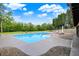 Relaxing in-ground pool with lounge seating and a view of the lush backyard at 4495 W Stones Crossing Rd, Greenwood, IN 46143