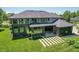 Aerial view of a two-story home with a well-maintained lawn, mature trees, and hardscaped patio at 4691 Pascagoula Run, Greenwood, IN 46143