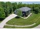 Aerial view of the property showing the circular driveway and extensive landscaping with mature trees at 4691 Pascagoula Run, Greenwood, IN 46143