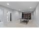 Basement with carpet flooring, ping pong table and book shelves at 4691 Pascagoula Run, Greenwood, IN 46143