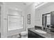 Bright bathroom features a shower and tub combination, granite vanity, and a decorative mirror at 4691 Pascagoula Run, Greenwood, IN 46143