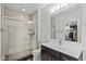 Bathroom with a tiled shower, dark wood vanity, and a large mirror at 4691 Pascagoula Run, Greenwood, IN 46143