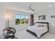 Serene bedroom features a modern ceiling fan and a large window with views of the landscaped yard at 4691 Pascagoula Run, Greenwood, IN 46143