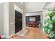 Inviting foyer leading to a dining area, featuring elegant hardwood floors, a grand doorway, and natural light at 4691 Pascagoula Run, Greenwood, IN 46143