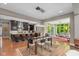Open-concept kitchen flowing into a dining and living area, featuring modern appliances, sleek cabinetry, and hardwood floors at 4691 Pascagoula Run, Greenwood, IN 46143