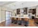 Modern kitchen boasts a large island with barstool seating and stylish pendant lighting at 4691 Pascagoula Run, Greenwood, IN 46143
