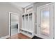 Mudroom featuring a built-in storage bench, hooks, and an exterior door with a frosted glass insert at 4691 Pascagoula Run, Greenwood, IN 46143