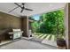 Covered outdoor patio with a grill, ceiling fan, and view of the lush backyard at 4691 Pascagoula Run, Greenwood, IN 46143