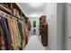 Spacious walk-in closet featuring custom shelving, clothing racks, and a bright window for natural light at 4691 Pascagoula Run, Greenwood, IN 46143