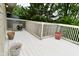 An exterior view of the back deck with potted plants and a white wooden railing around its perimeter at 5135 Moller Rd, Indianapolis, IN 46254