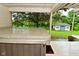 A view of the hot tub on the covered back porch and a view of the lawn and small cottage out back at 5135 Moller Rd, Indianapolis, IN 46254
