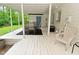 Here is an exterior view of the back porch, with some seating and a view to the yard beyond at 5135 Moller Rd, Indianapolis, IN 46254