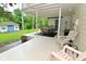 This is an exterior view of the back porch with plenty of seating and a view to a small cottage at 5135 Moller Rd, Indianapolis, IN 46254