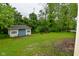 An exterior shot of a small cottage located in the backyard of this property at 5135 Moller Rd, Indianapolis, IN 46254