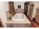 Elegant bathroom featuring a soaking tub, tiled walls, and a separate shower, offering a luxurious and relaxing experience at 5135 Moller Rd, Indianapolis, IN 46254