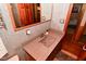 Bathroom features a granite countertop, wooden cabinets, and a decorative framed mirror at 5135 Moller Rd, Indianapolis, IN 46254