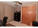 Bedroom with closet, ceiling fan and light fixture, and neutral decor at 5135 Moller Rd, Indianapolis, IN 46254
