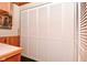 Pantry features bi-fold doors, ample shelving, and a view into the laundry room at 5135 Moller Rd, Indianapolis, IN 46254