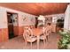 Formal dining room with wood-paneled walls, a large table with eight chairs, and elegant lighting at 5135 Moller Rd, Indianapolis, IN 46254