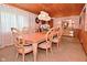 Dining area featuring a wooden table and chair set, accented by a traditional chandelier and ample natural light at 5135 Moller Rd, Indianapolis, IN 46254