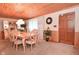 Dining area with a large table set for eight, complemented by wood paneling and soft natural light at 5135 Moller Rd, Indianapolis, IN 46254