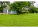 An exterior shot of the house and a three car garage surrounded by a well manicured front lawn at 5135 Moller Rd, Indianapolis, IN 46254