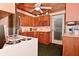 Well-lit kitchen with wood cabinetry, stainless steel appliances, and a door to the outside at 5135 Moller Rd, Indianapolis, IN 46254