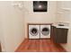 Well-organized laundry room with washer, dryer, storage, and a television, creating a functional and convenient space at 5135 Moller Rd, Indianapolis, IN 46254