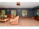 Spacious living room with large windows, plush seating, and a warm, inviting atmosphere at 5135 Moller Rd, Indianapolis, IN 46254
