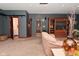 Spacious living room area with tiled steps, a wooden entertainment center, and plush couches at 5135 Moller Rd, Indianapolis, IN 46254